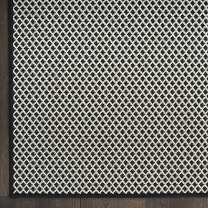 Black and ivory diamond-patterned runner rug with a slim black border and woven texture, ideal for living room accents.