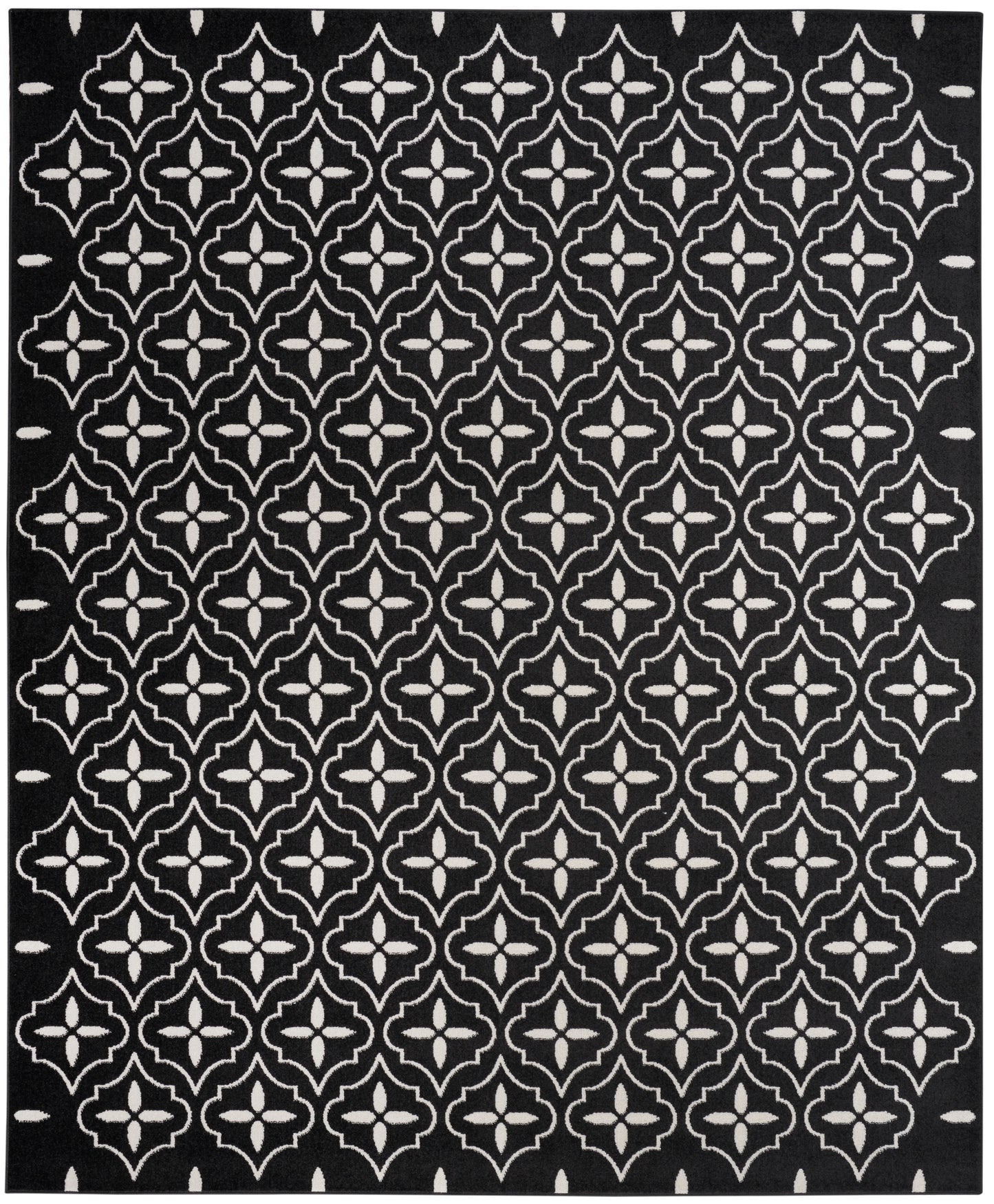 Black rug featuring a white repeating quatrefoil lattice pattern for bold geometric decor.