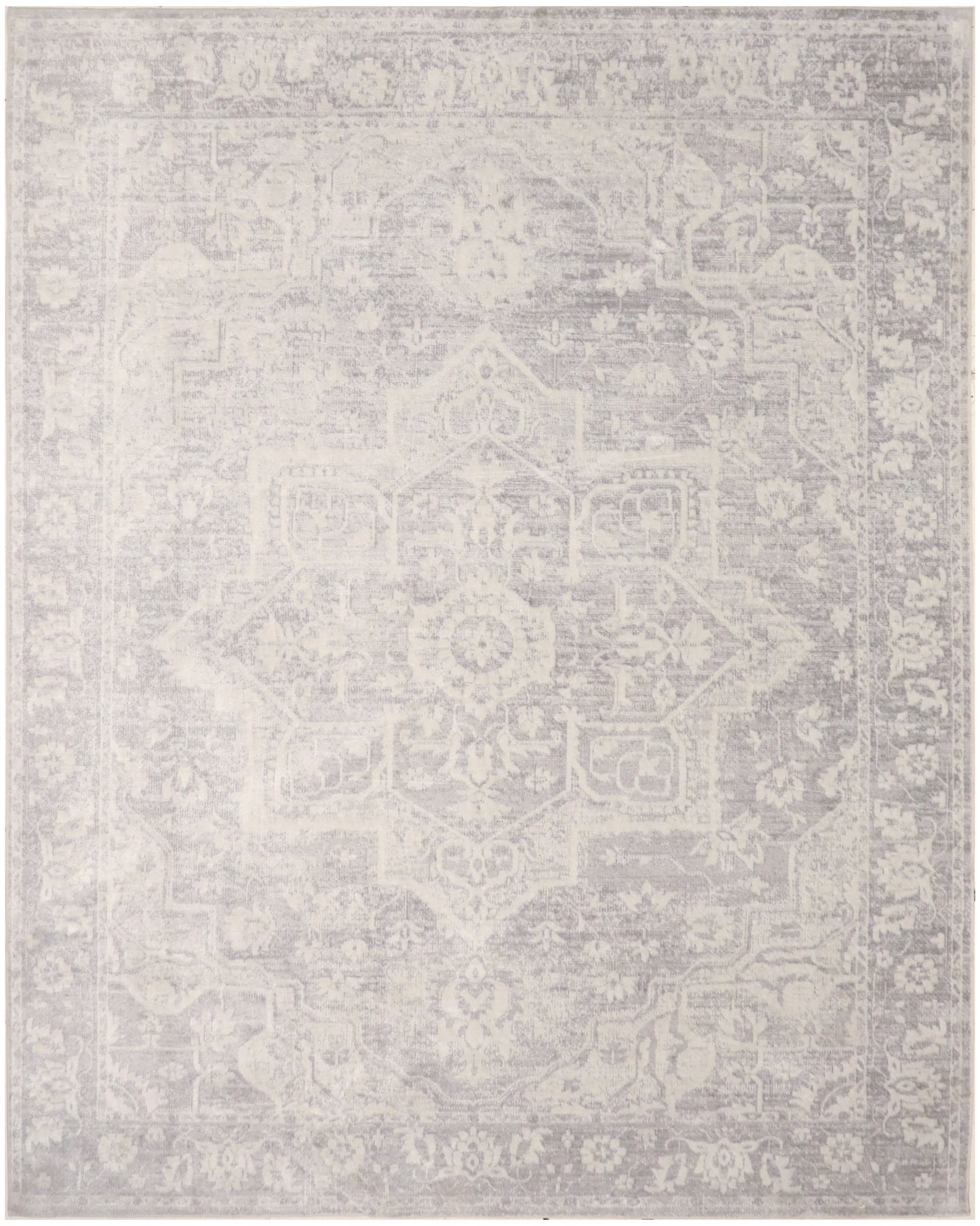 Light gray distressed area rug with faded traditional medallion and floral border; neutral, rectangular.