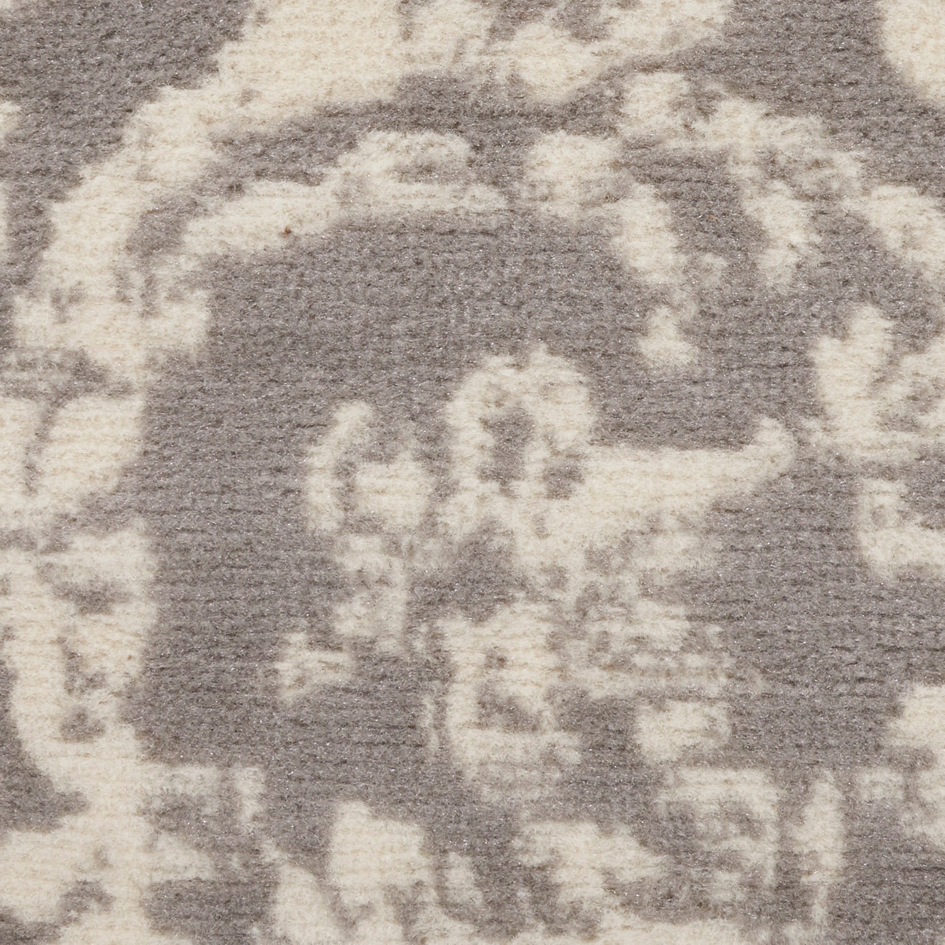 Gray rug with cream abstract damask motif in soft, tufted pile for living room decor.