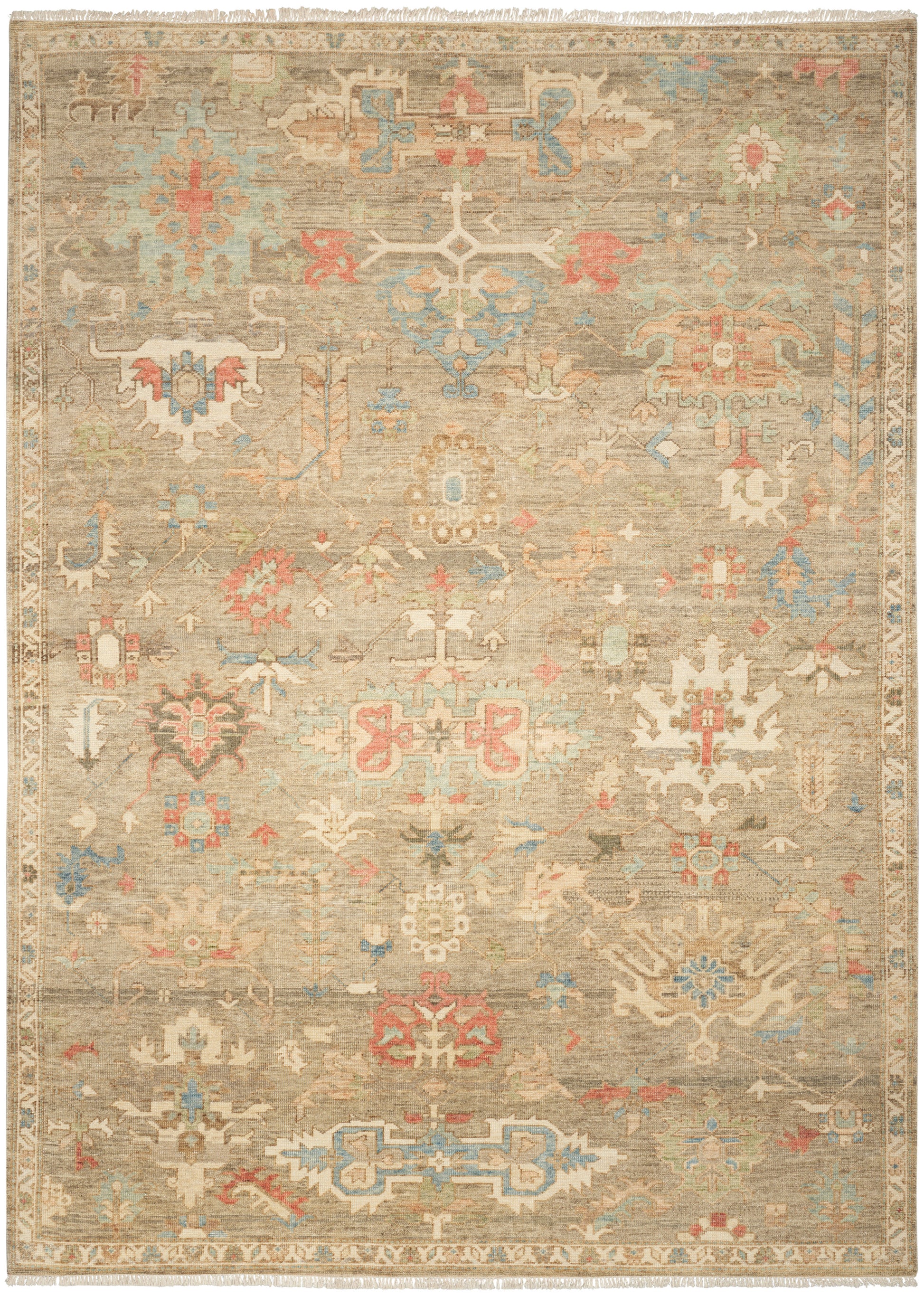 Beige distressed oriental rug with pastel blue, pink and gold geometric medallions; fringed edges.