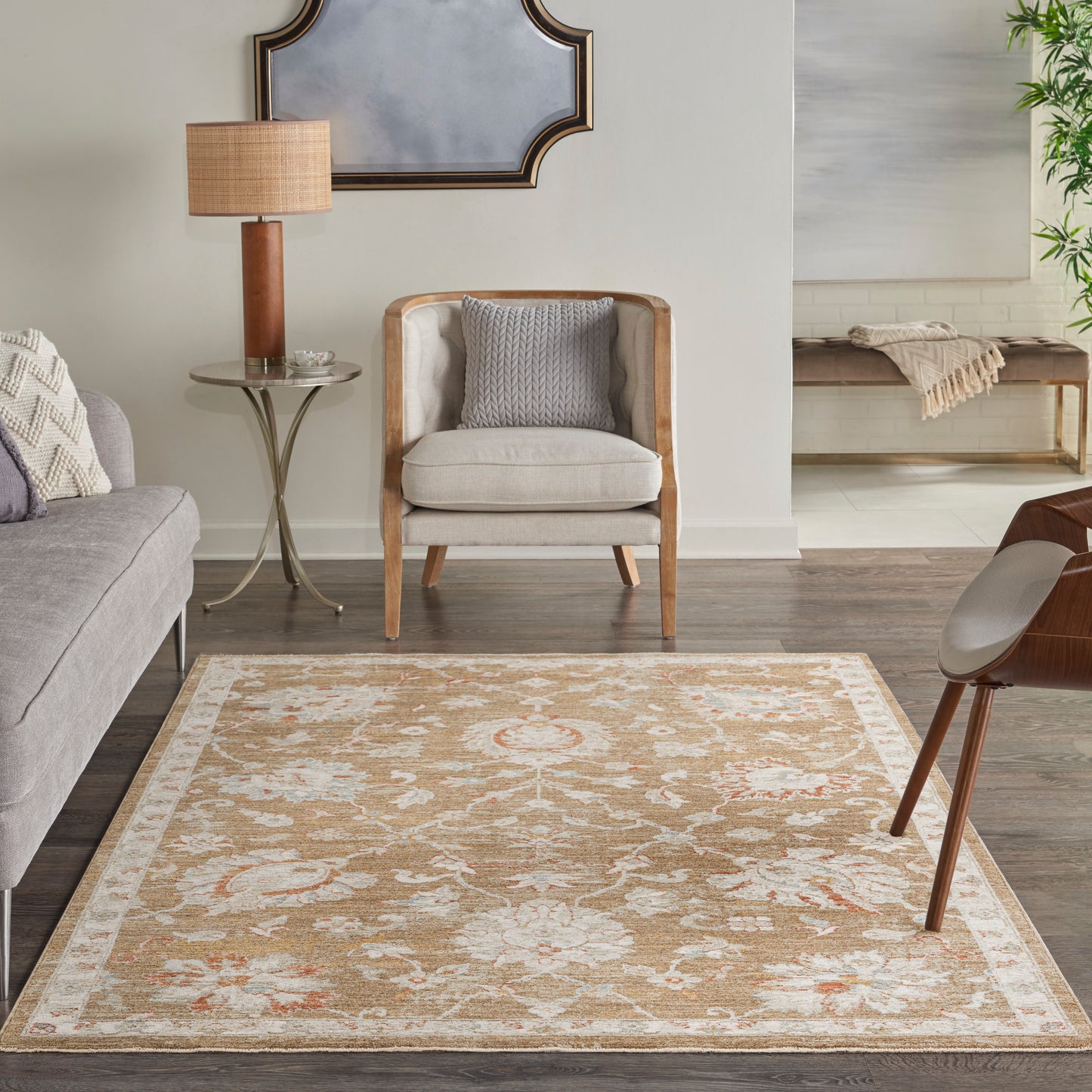 Beige ornate area rug (4' x 6') with peach accents in a mid-century living room, paired with a gray sofa and a wood-framed armchair.