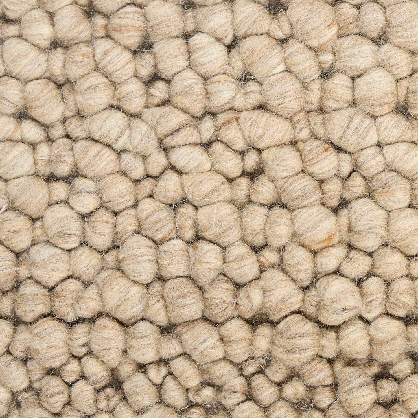 Beige chunky boucle rug with rounded knobby loops; soft natural fiber texture.