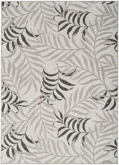 Neutral gray area rug with light and dark palm leaf pattern; contemporary botanical design for living room.