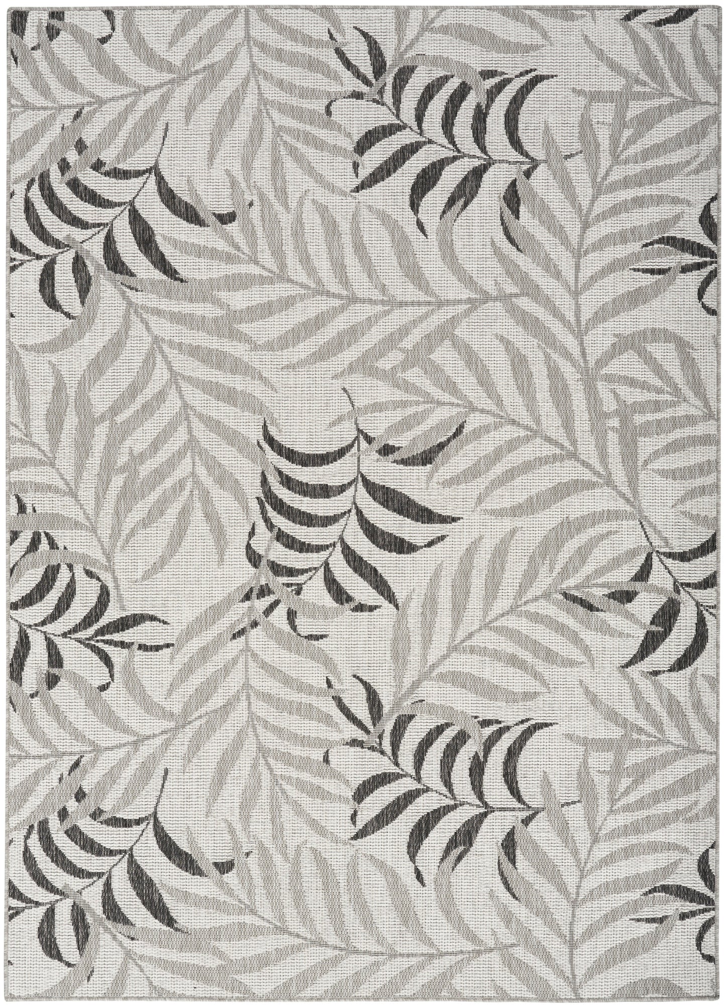 Grey tropical leaf rug with overlapping palm fronds in light/dark grey on soft neutral background.