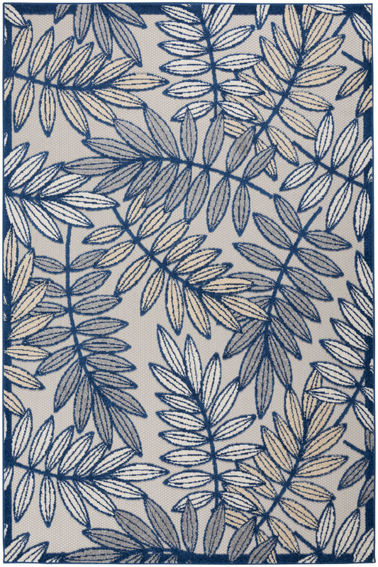 Navy leaf-pattern rug on beige background with blue border; botanical fern-like design.