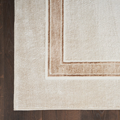 Beige textured area rug with tan outer and inner borders on dark hardwood floor.