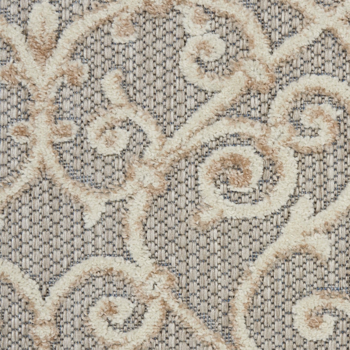 Cream damask scroll pattern on a gray textured jacquard; plush rug or upholstery fabric.
