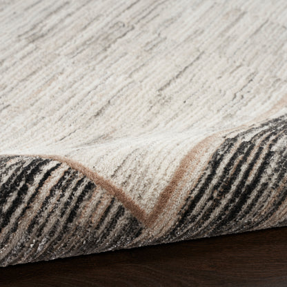 Soft, high-pile area rug with cream and light gray tones, charcoal striped edge and beige border, folded corner.