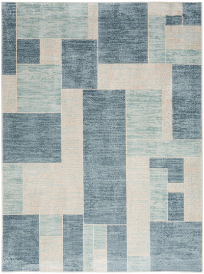 Geometric patchwork area rug in blue, light blue and cream tones with rectangular blocks; modern abstract design.