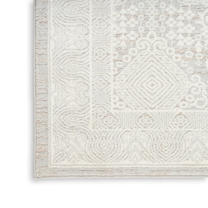 Cream and ivory patterned area rug with a soft textured pile and bordered edge, ideal for living room or bedroom.