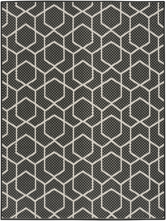 Black rug with white hexagon lattice pattern and dotted interior detail.