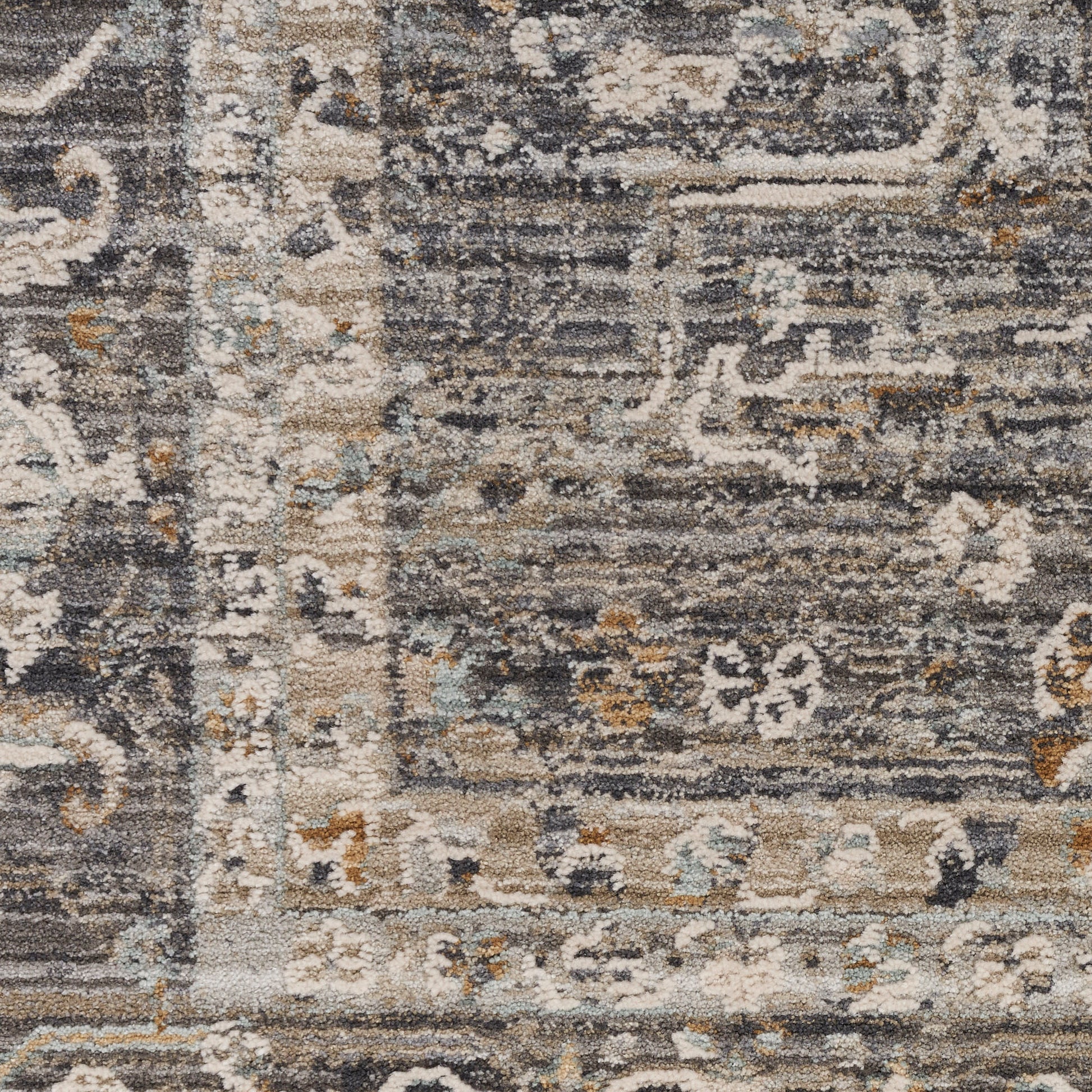 Rectangular textured runner rug in gray, ivory, beige and pale blue with ornate floral motifs and borders.