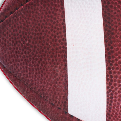 Close-up burgundy pebbled leather football panel with a white stripe and visible stitching.