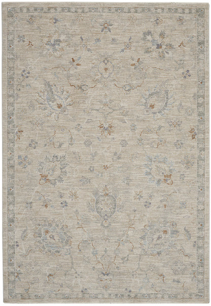 Muted beige oriental rug with pale blue and gray floral motifs, rust accents and a decorative border.