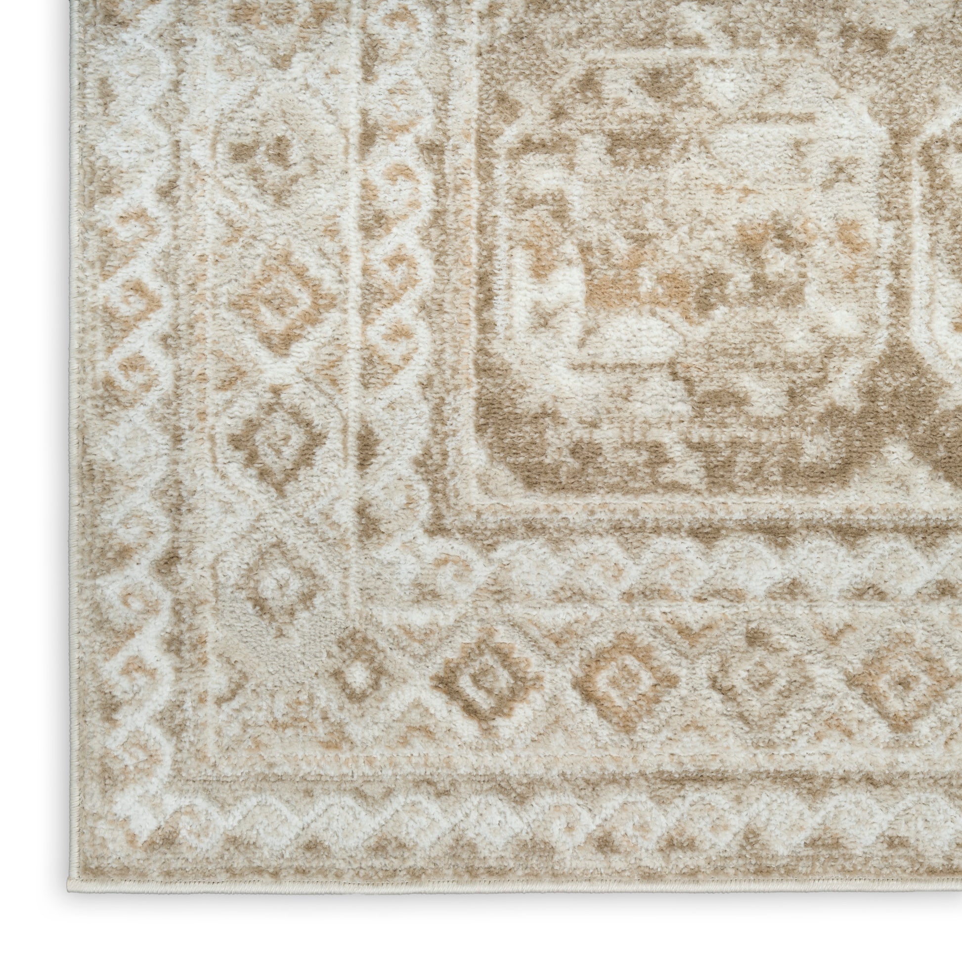 Beige distressed oriental rug with ivory patterns and border; plush pile, rectangular area rug.
