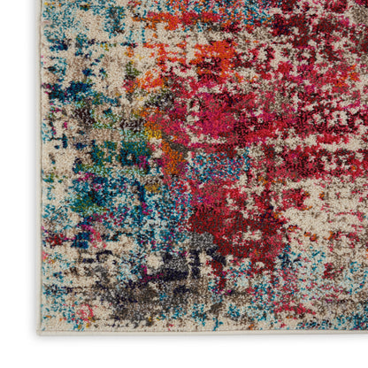 Close-up of a multicolor abstract rug with plush shag fibers in pinks, reds, blues, teals and beige.