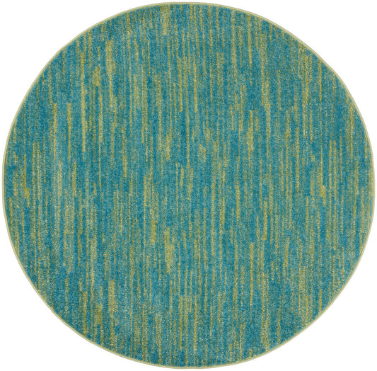 Round teal rug with lime-green vertical streaks; modern abstract pattern.