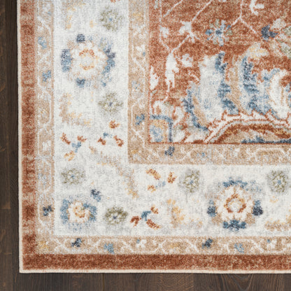 Oriental-style area rug with ivory field, rust border and blue floral motifs.