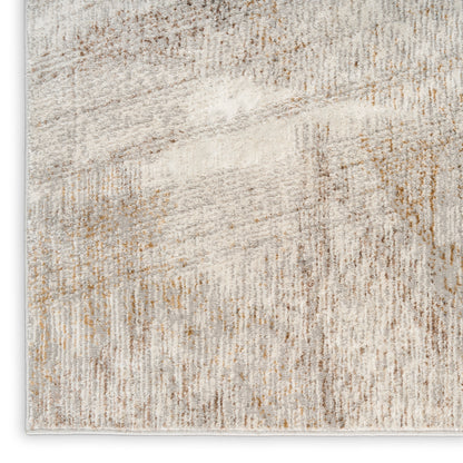 Abstract beige cream area rug with taupe and light brown distressed pattern, soft pile.
