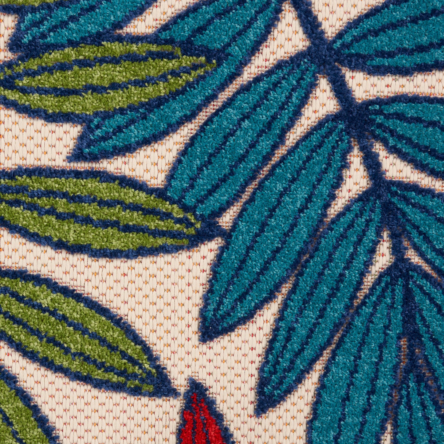 Close-up of green and blue tropical leaf print on beige rug, 8' runner.