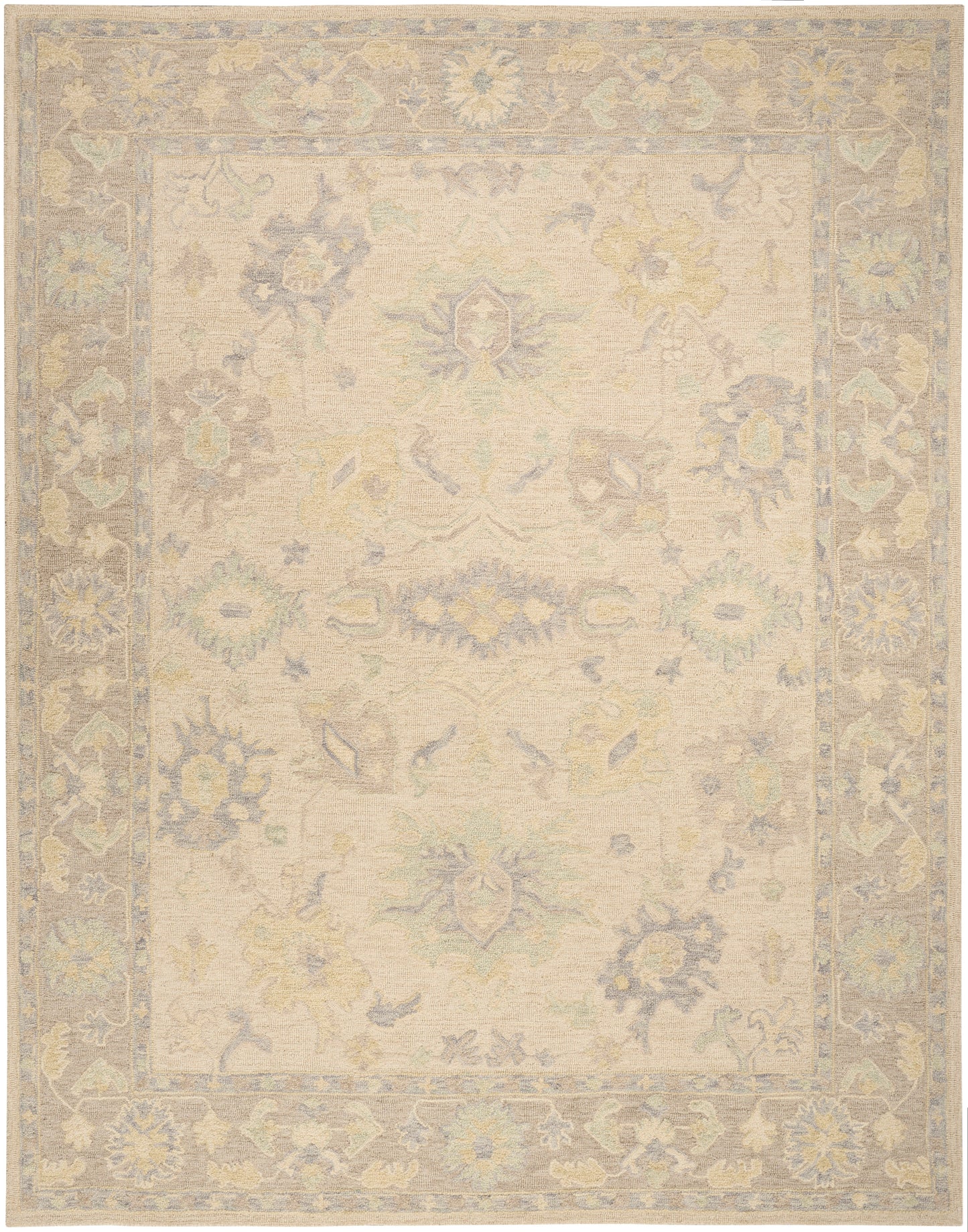 Pastel-toned vintage rug with cream field and soft blue, yellow, and mint floral motifs; lavender border.