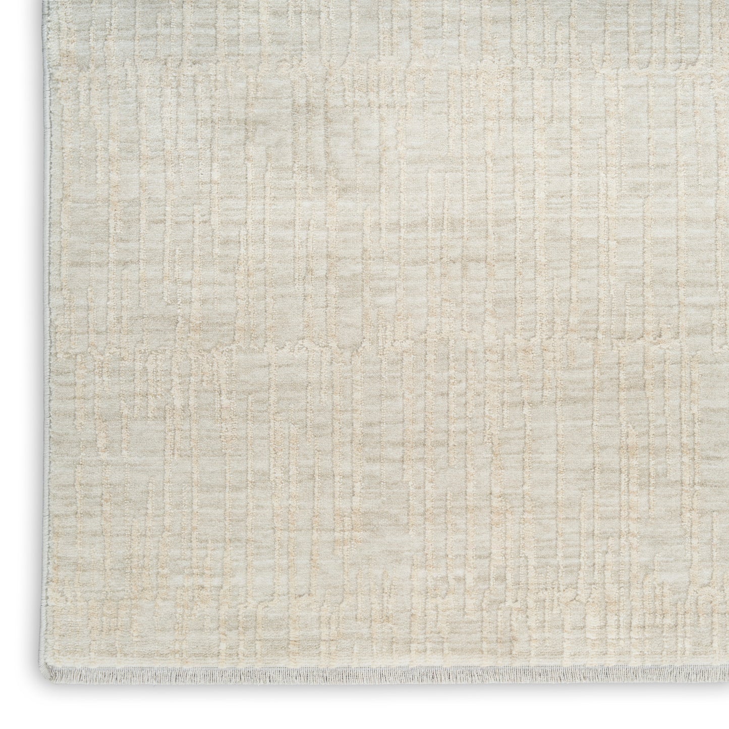 Cream and ivory textured area rug with a subtle geometric block pattern and short fringe along the bottom edge.