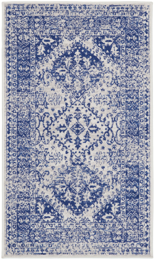 Blue & white distressed oriental rug with central medallion, floral patterns, and bordered edges.