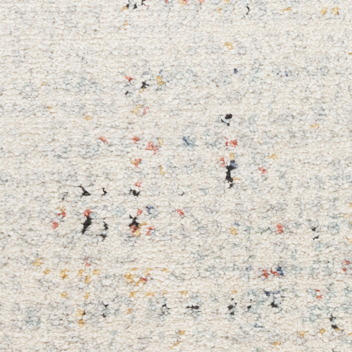 Cream shag rug with multicolor flecks in red, yellow, blue and black; soft, textured loop pile.