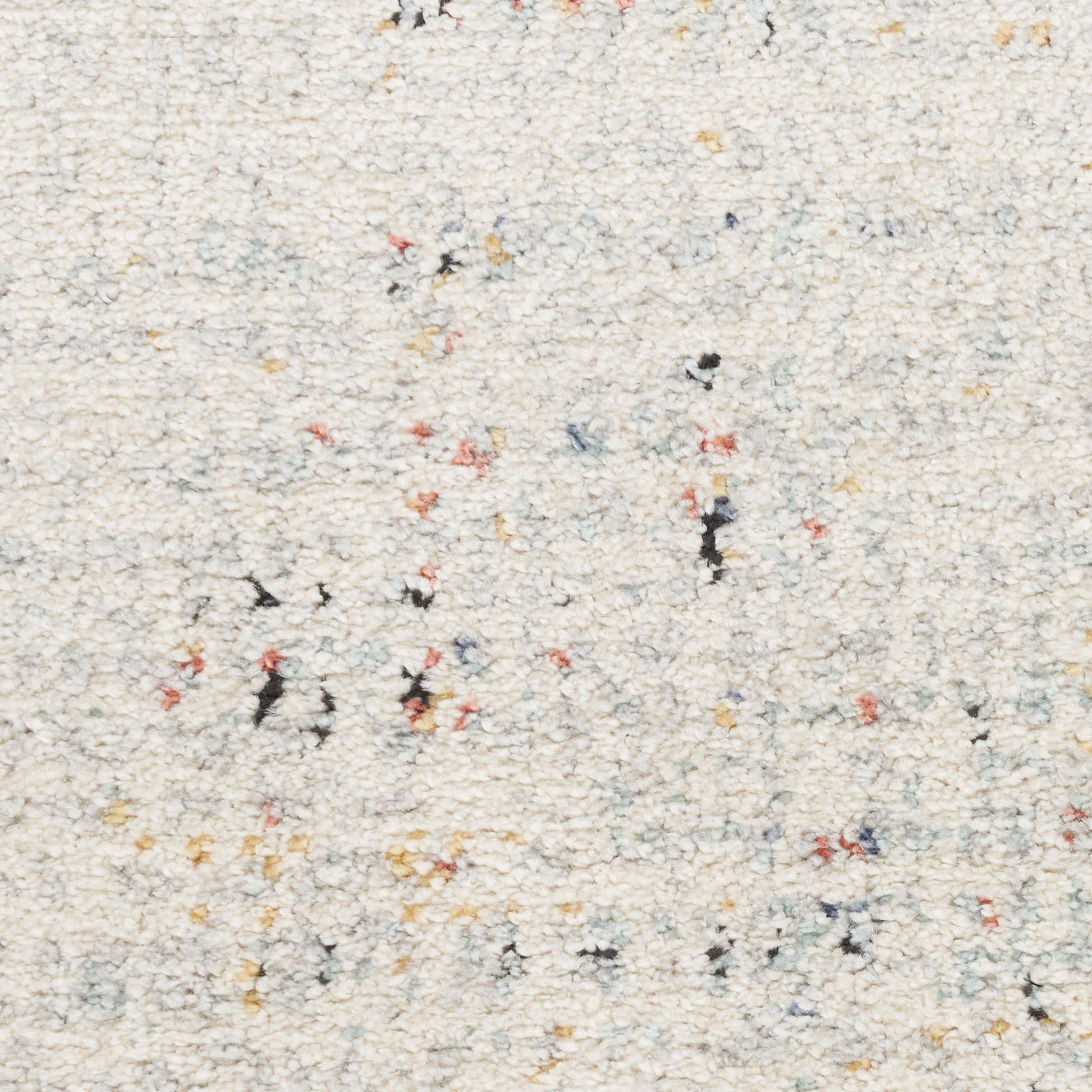 Cream shag rug with multicolor flecks in red, yellow, blue and black; soft, textured loop pile.
