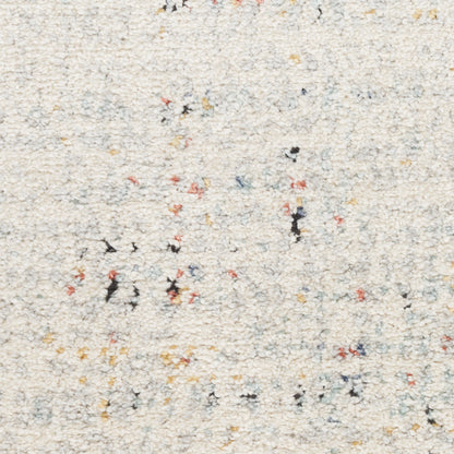 Cream shag rug with multicolor flecks in red, yellow, blue and black; soft, textured loop pile.