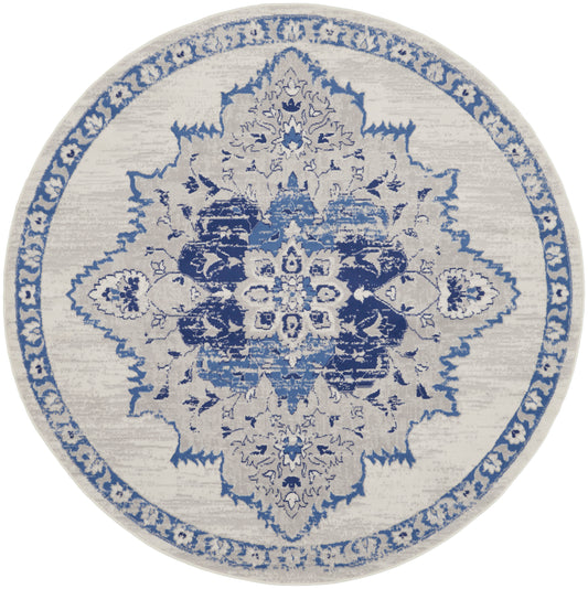 Round beige area rug with blue intricate medallion design and border, oriental/traditional style.