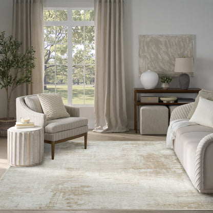 Neutral living room with cream sofa and armchair, beige curtains, textured rug, round side table, and console with vase.