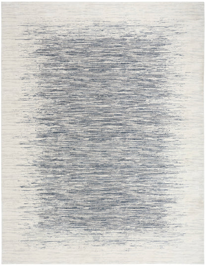 Rectangular area rug with cream background and navy-blue horizontal brushstrokes forming a soft, blurred central band.