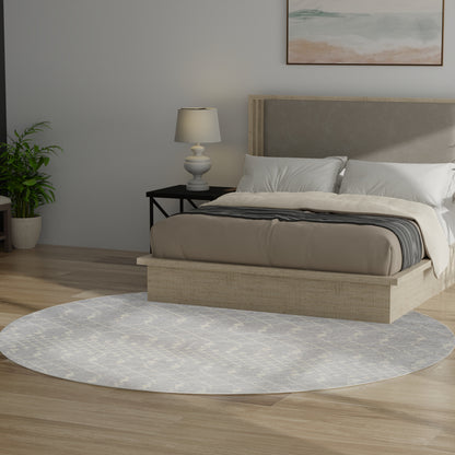 Round gray Bohemian rug on floor in a bedroom scene; plant & lamp visible.