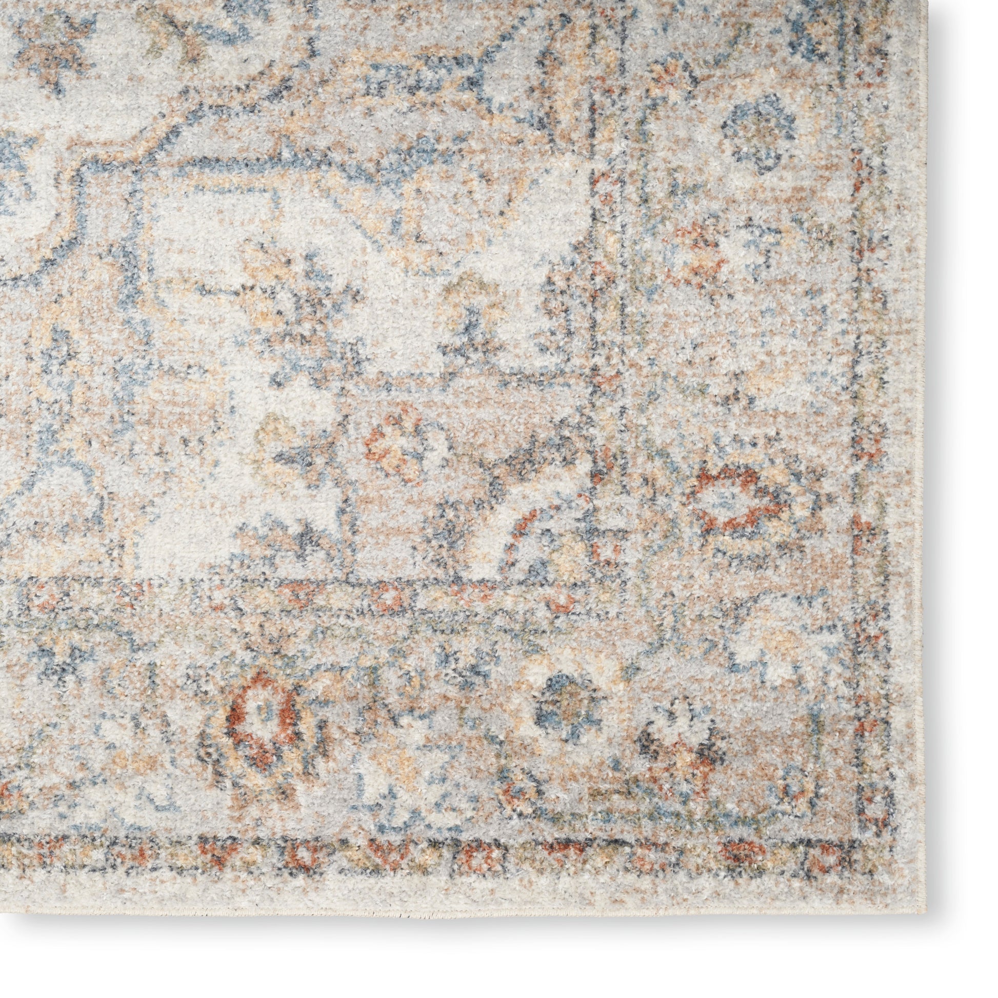 Distressed ivory oriental area rug with blue, tan and rust floral border; rectangular vintage style.