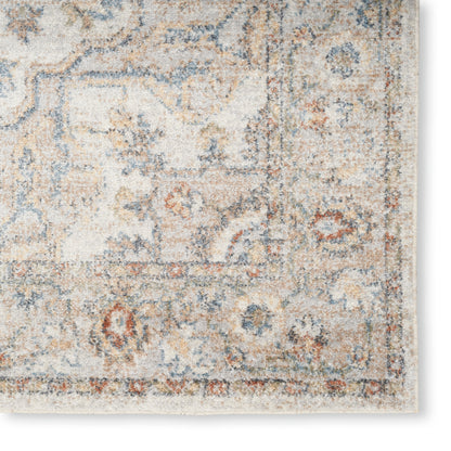Distressed ivory oriental area rug with blue, tan and rust floral border; rectangular vintage style.