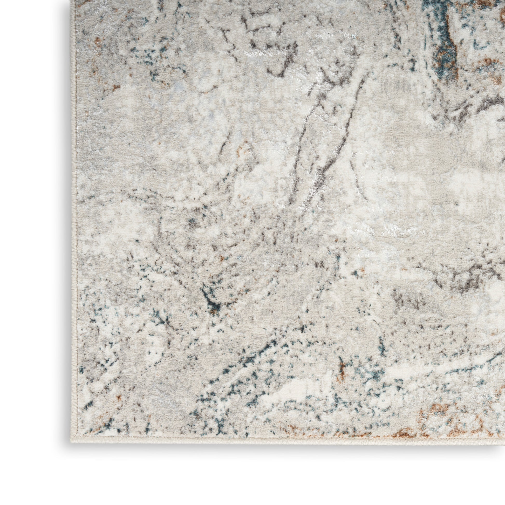 Close-up of a light gray-beige abstract runner rug with blue and rust veining; plush pile and stitched edge.