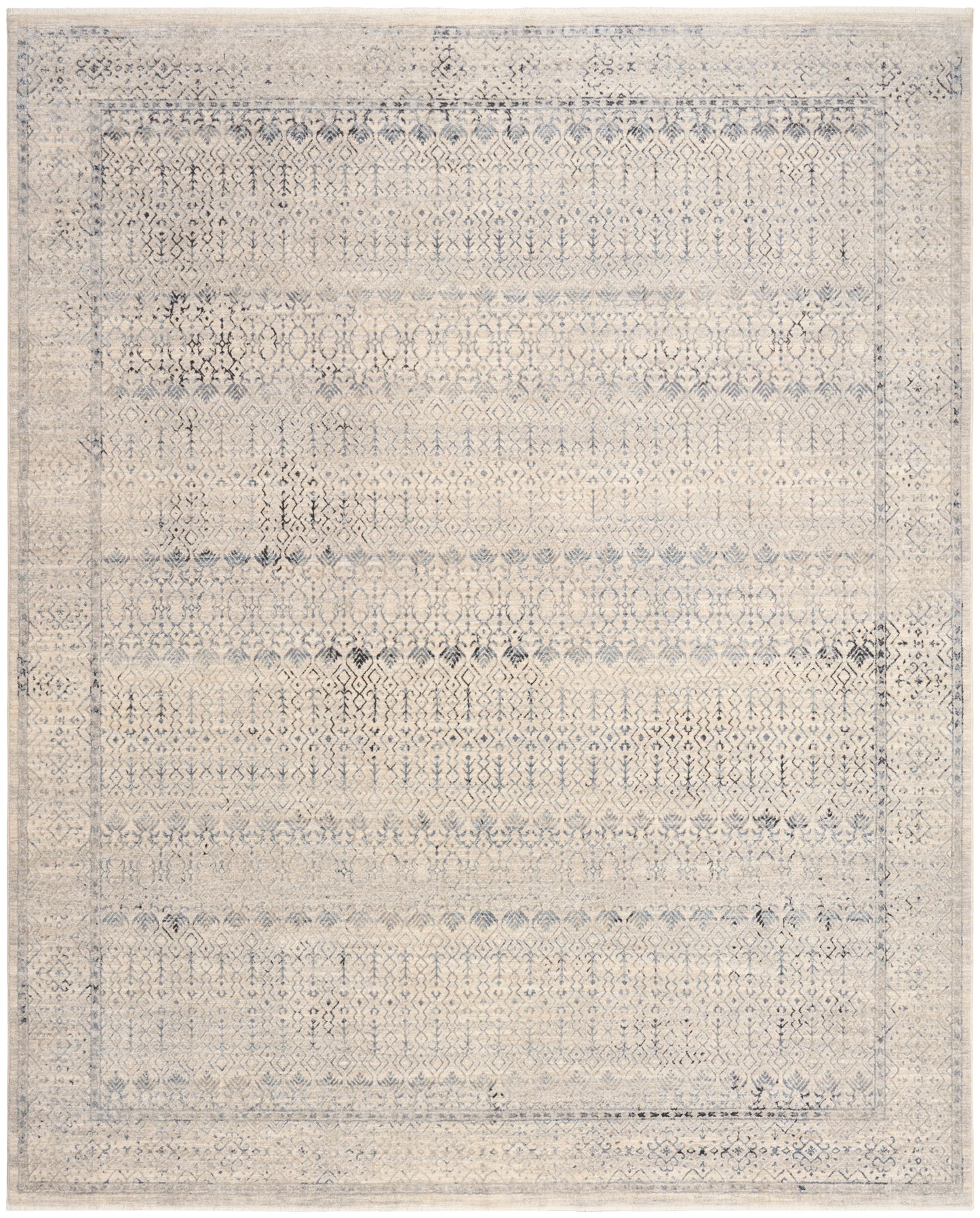 Distressed beige-blue oriental area rug with faded diamond motifs and a bordered frame.