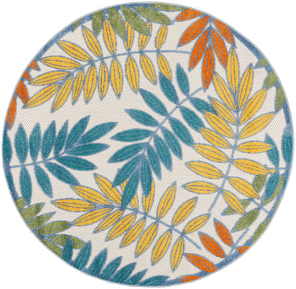 Round woven rug with colorful leaf motif in yellow, teal, orange and green on white background.