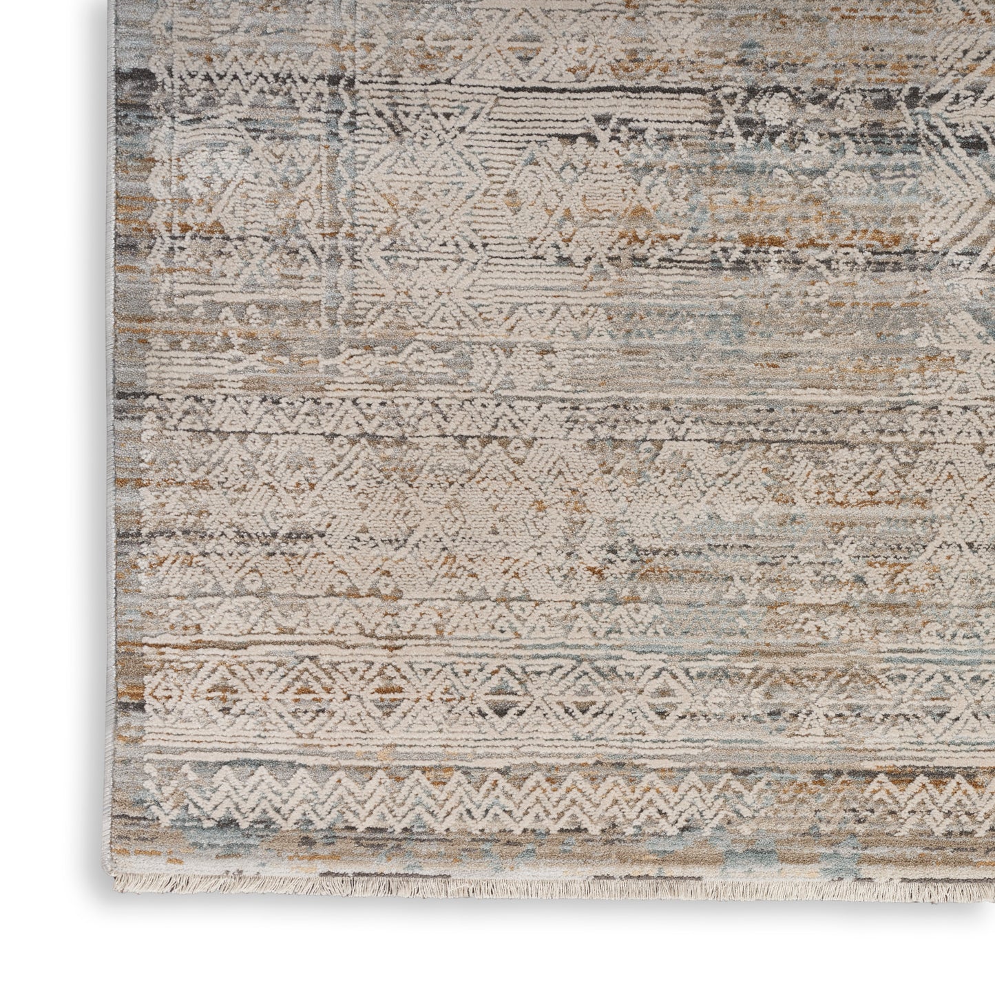 Distressed geometric patterned area rug in ivory, beige, blue-gray tones with fringe edges.