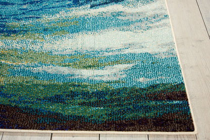 Abstract blue-green rug with wave motif, teal, white highlights, dark bottom border, laid on light wood floor.