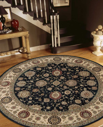 Round oriental rug with navy center and cream border, ornate floral medallions; perfect foyer accent.