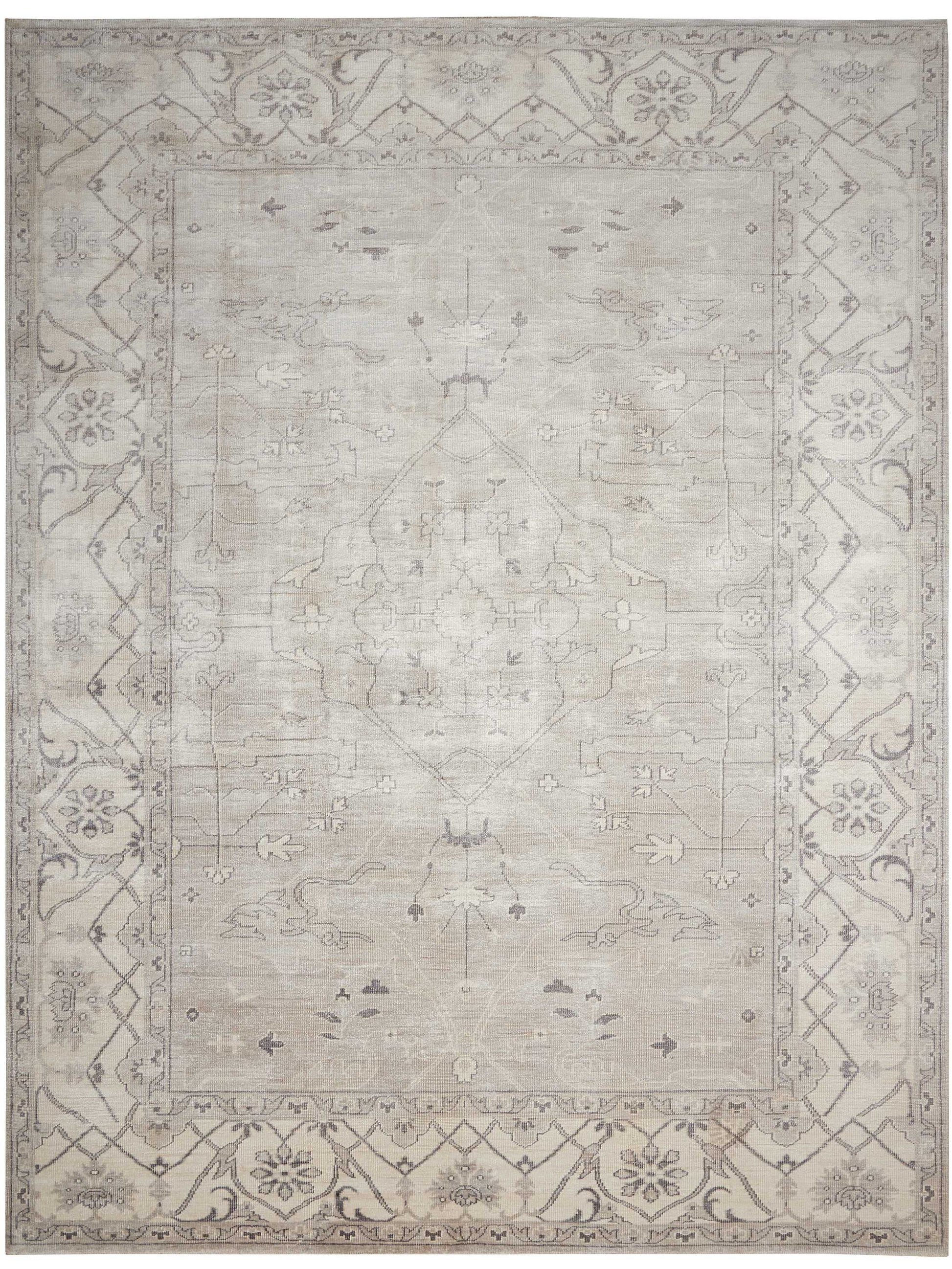 Muted gray-beige oriental rug with a subtle central medallion and ornate floral border.