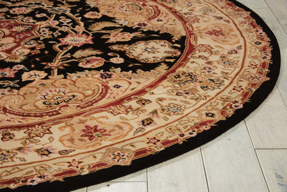 Round oriental rug with black central field, cream-beige border adorned with red floral motifs; decorative floor covering.