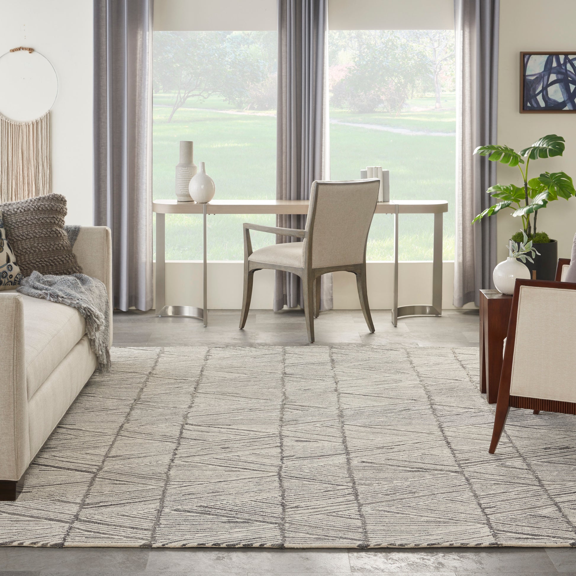 Gray geometric rug in a bright room with a potted plant and large windows.