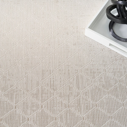 Cream textured rug with a diamond lattice pattern; white tray with black coiled cords in the corner.