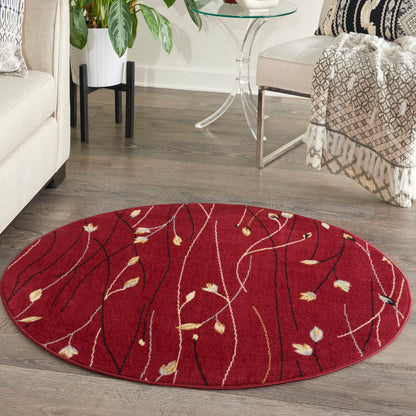 Round red area rug with white and gold botanical lines, in a cozy living room.