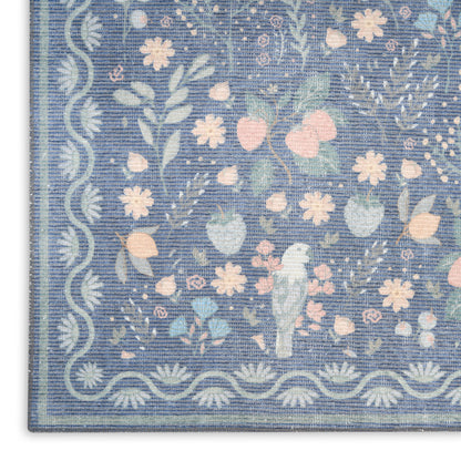 Blue floral rug with pastel pink & white flowers, light blue leaves, scalloped border & small central bird motif.