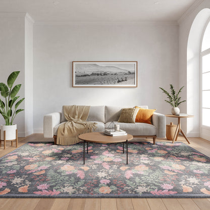 Modern living room: light gray sofa, beige throw, floral rug, round wood coffee table, tall plant, arched window.
